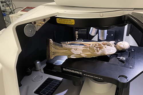 An ivory object, assumed to be of Asian elephant origin, under the microscope inside a Renishaw in via Raman microspectrometer